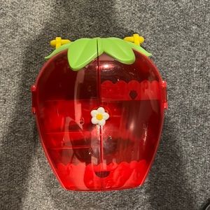 strawberry makeup/jewelry holder. good as new. has a handle.